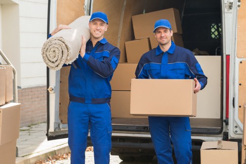 Professional removal team loading furniture for a Queens Park home move