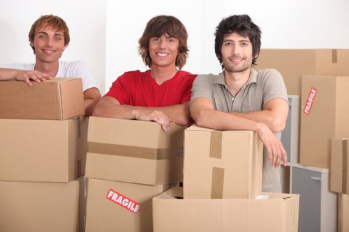 Professional moving service in Queens Park loading fragile items safely