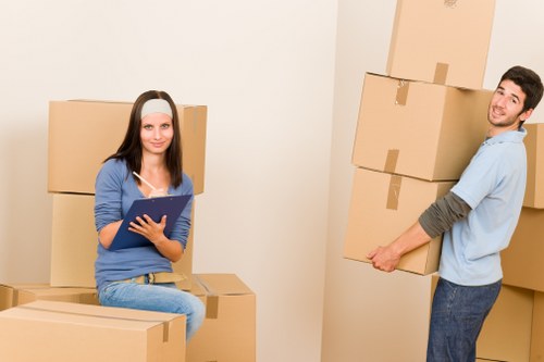 Careful wrapping and boxing of household items during a Queens Park move