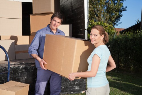 Removal vehicle and packed household items for a Queens Park move